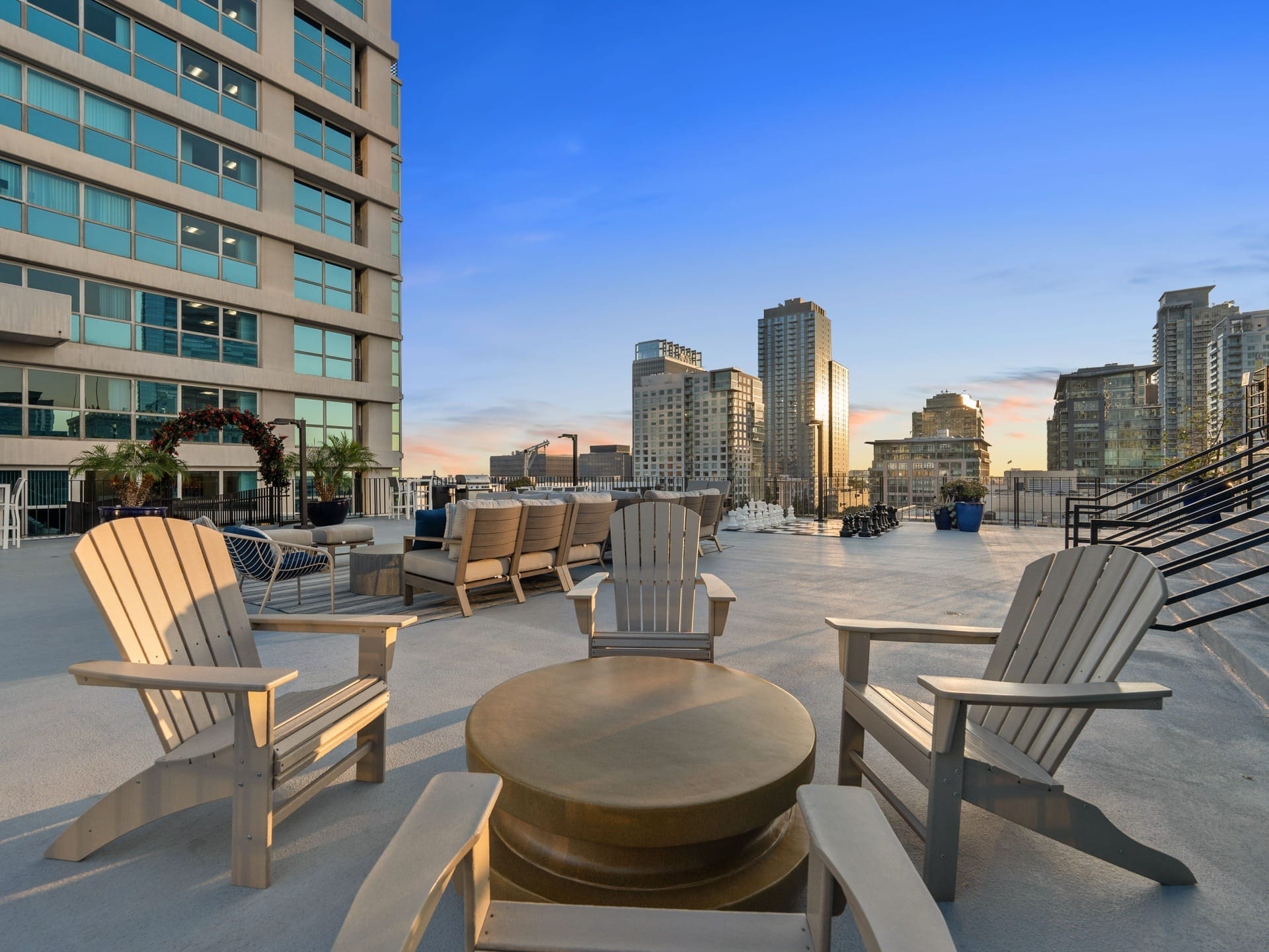 a large patio with rocking chairs and a view of the city