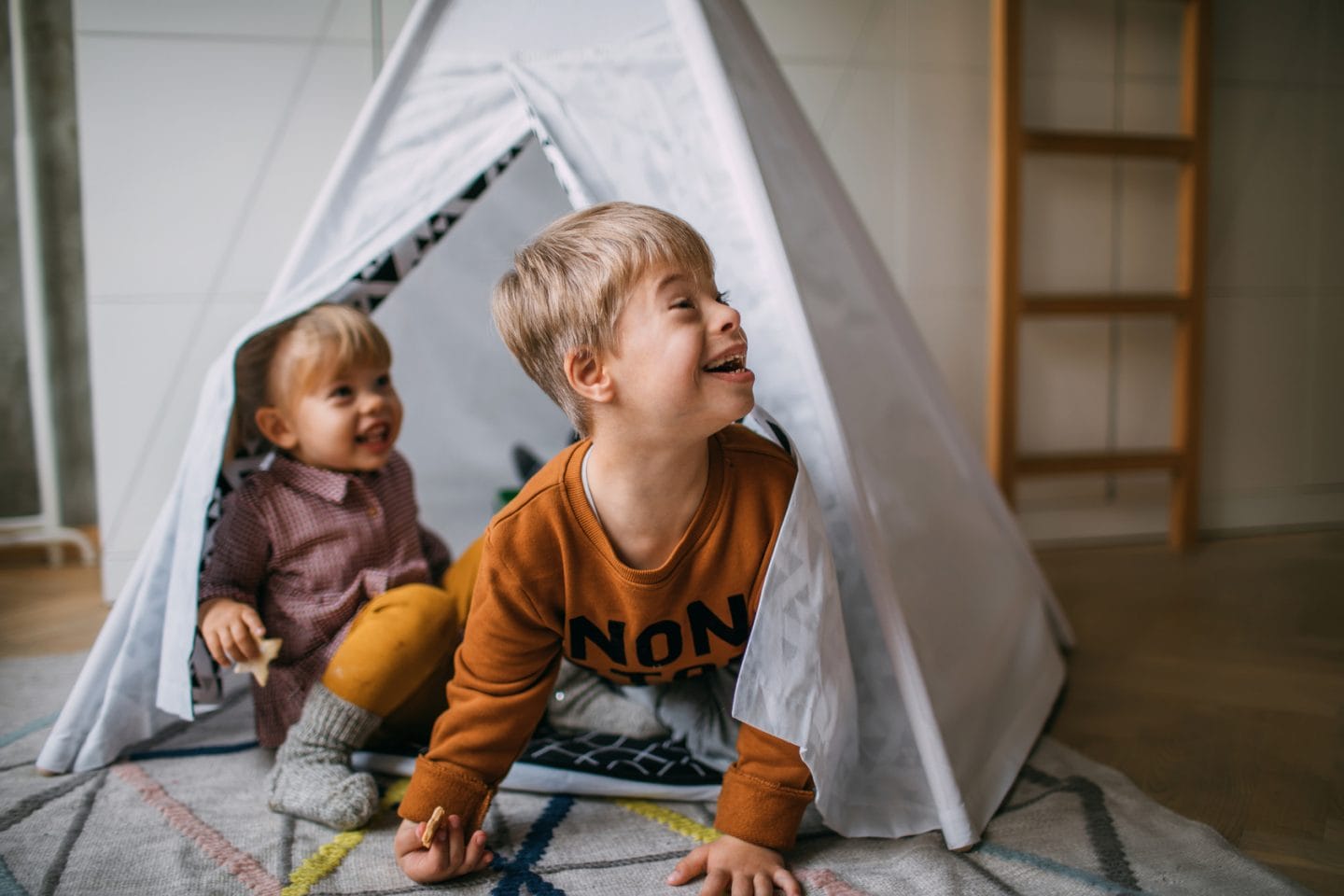 two young boys playing in tent