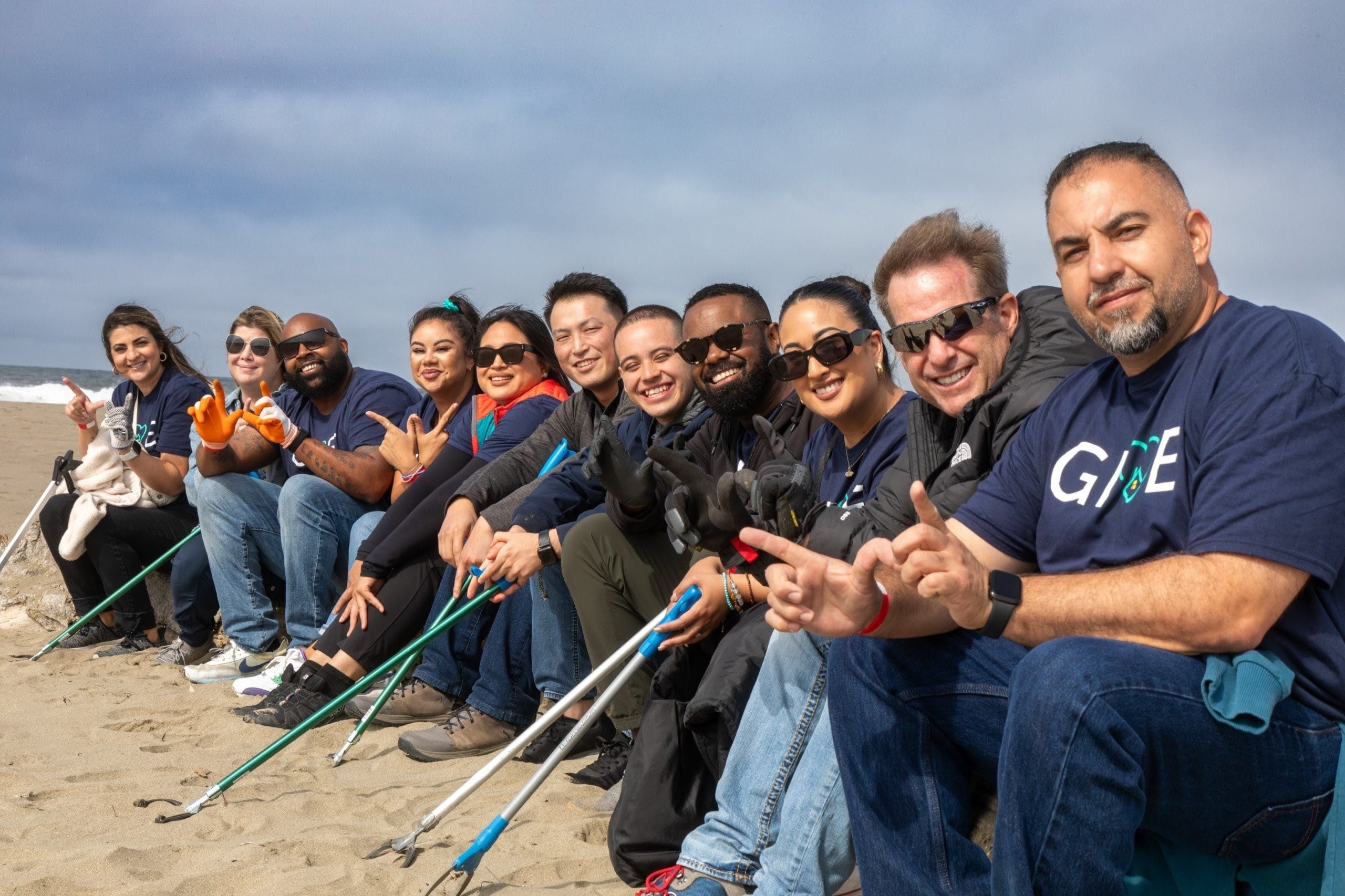 a group of people sitting on the beach
